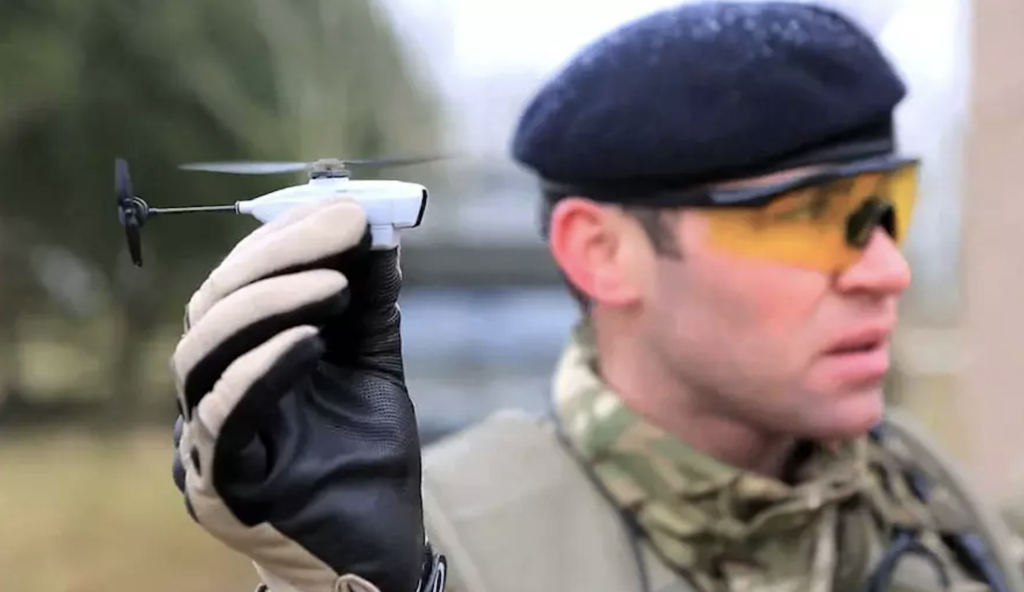 soldier holding mini drone in how do drones work article